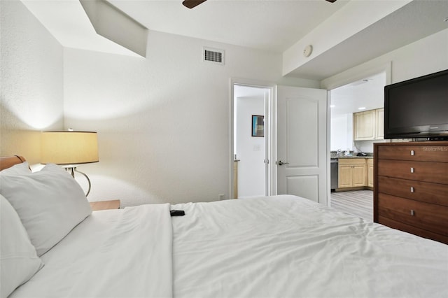 bedroom with ensuite bathroom and ceiling fan