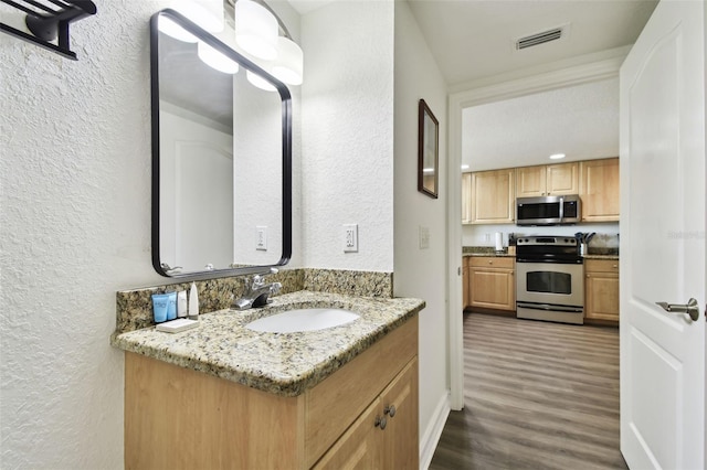 bathroom featuring hardwood / wood-style floors and vanity