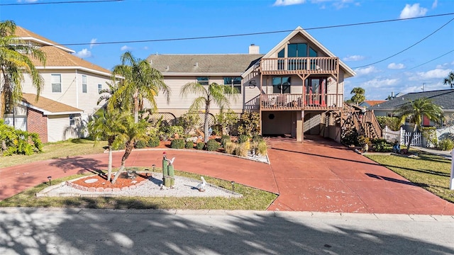 view of front of property with a carport and a balcony