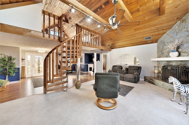 living room featuring a stone fireplace, high vaulted ceiling, hardwood / wood-style floors, track lighting, and wood ceiling