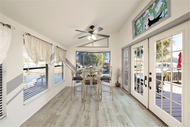 sunroom / solarium featuring ceiling fan, lofted ceiling, and french doors