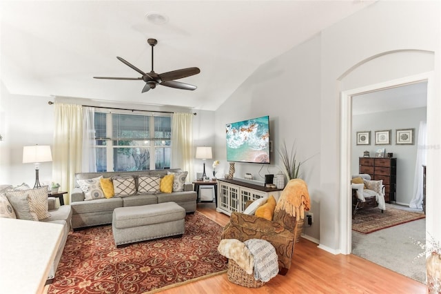 living room featuring hardwood / wood-style flooring, ceiling fan, and lofted ceiling