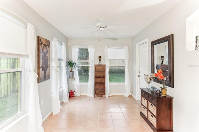 interior space with ceiling fan