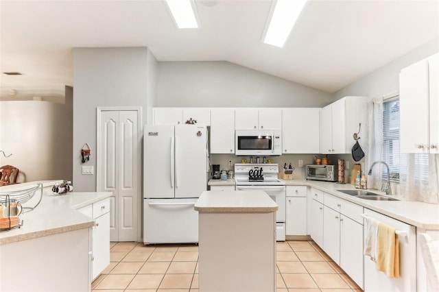 kitchen with a center island, white appliances, white cabinets, sink, and vaulted ceiling