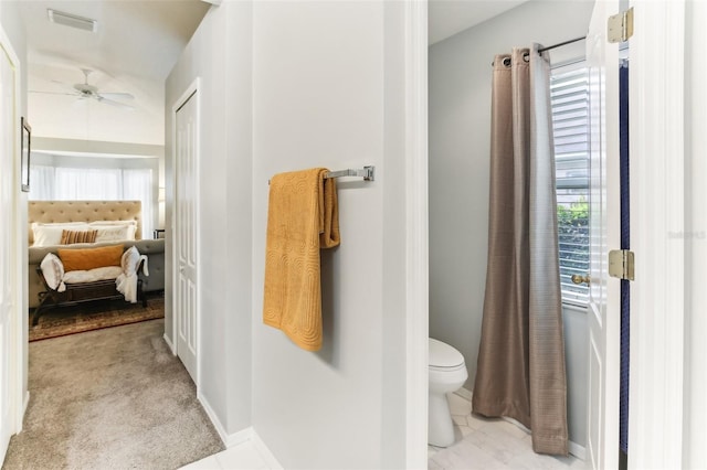 bathroom with ceiling fan and toilet