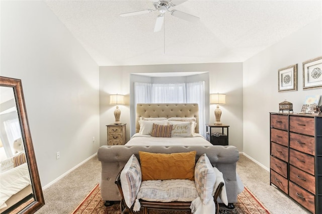 bedroom featuring ceiling fan, light colored carpet, a textured ceiling, and vaulted ceiling