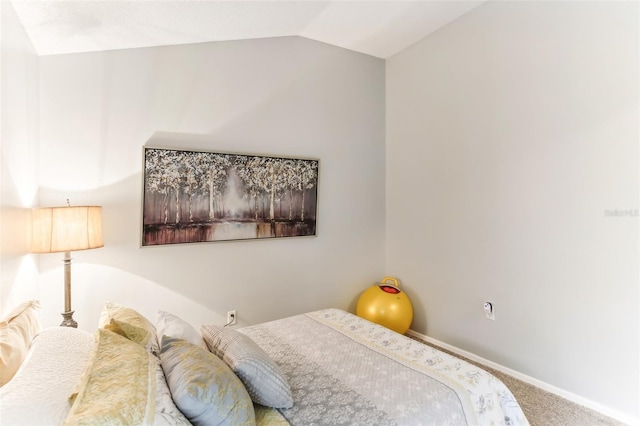 carpeted bedroom with lofted ceiling