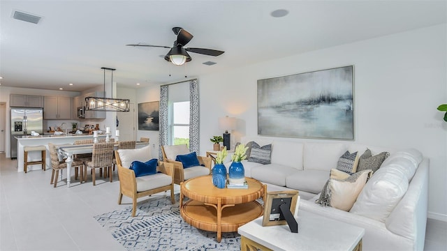 living room featuring ceiling fan and sink