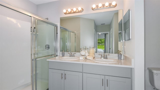 bathroom with vanity, toilet, and an enclosed shower