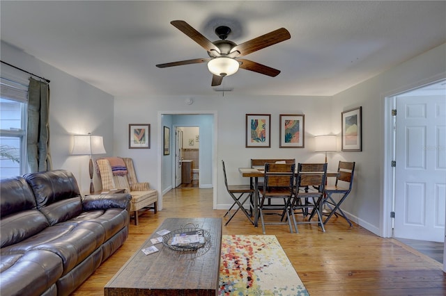 living room with ceiling fan and light wood-type flooring