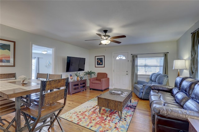 living room with light hardwood / wood-style floors and ceiling fan