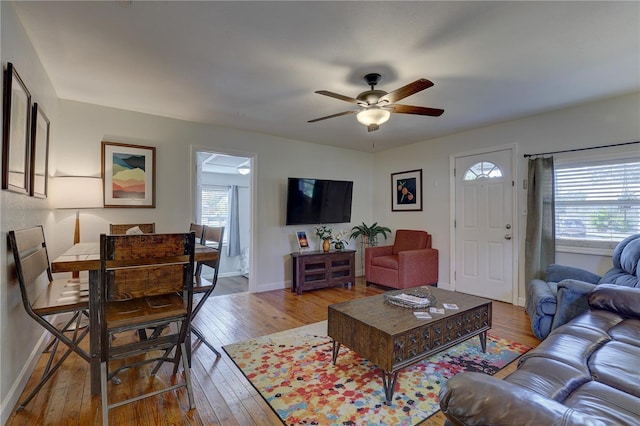 living room featuring ceiling fan and light wood-type flooring