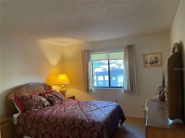 carpeted bedroom featuring a textured ceiling