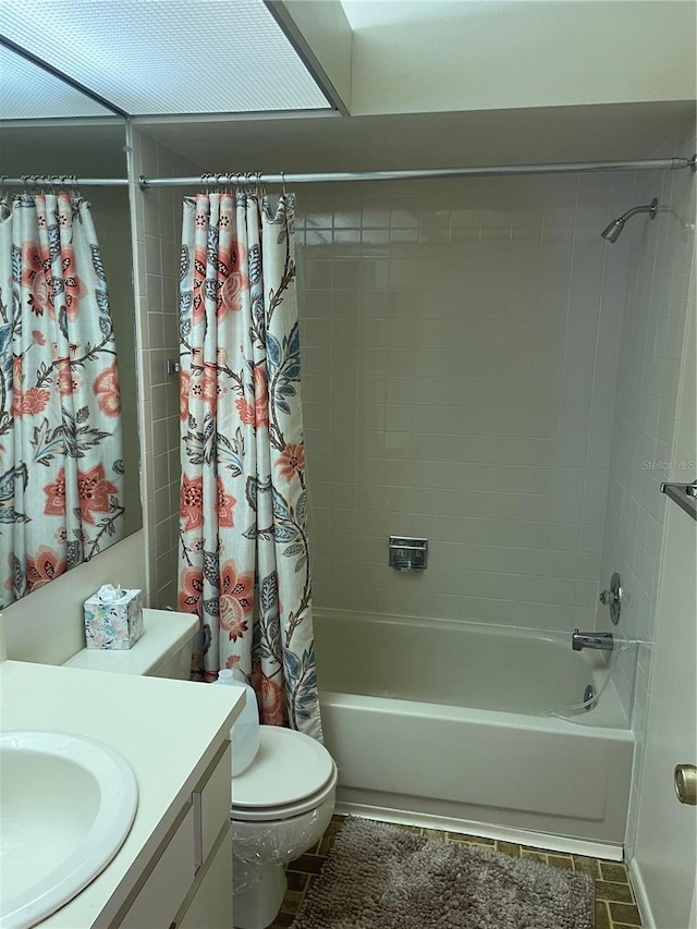 full bathroom with vanity, toilet, and shower / tub combo with curtain