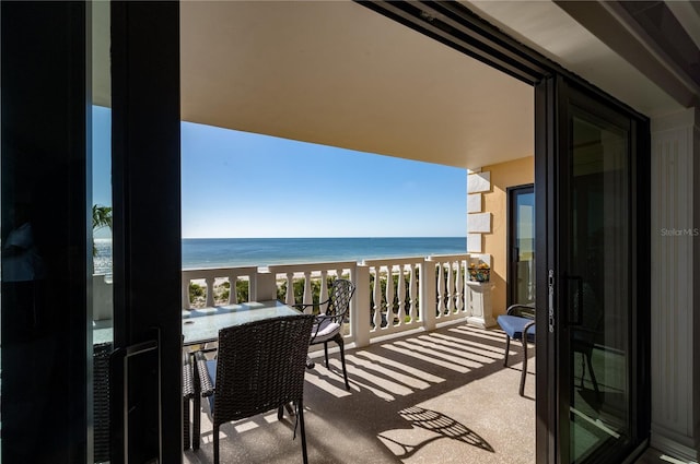 balcony featuring a water view and a view of the beach