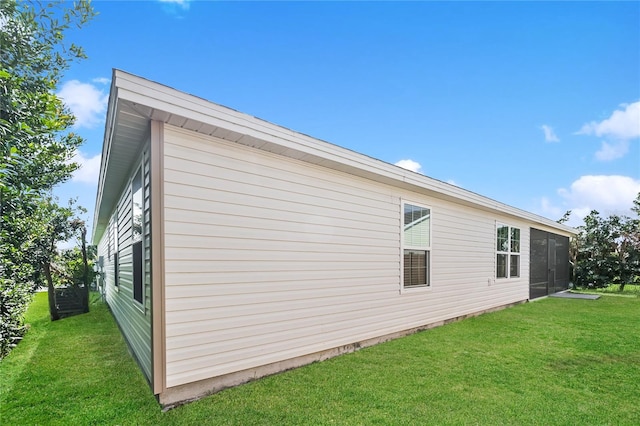 view of side of home with a lawn