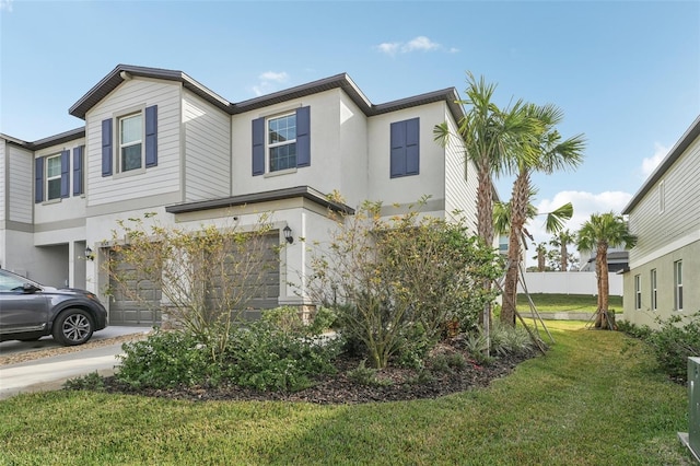 view of front of house with a front yard and a garage