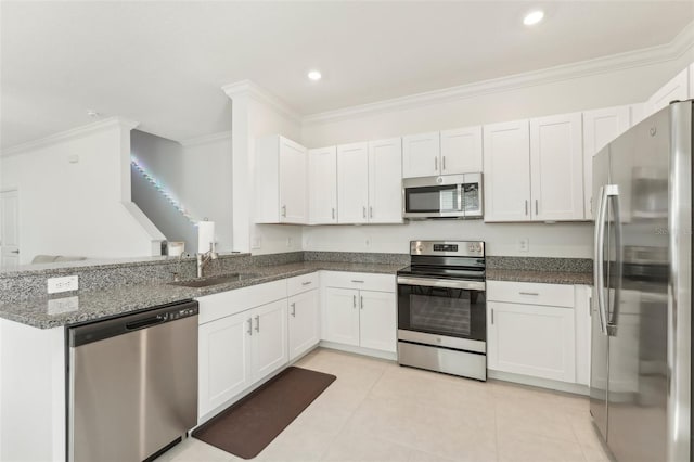 kitchen featuring light tile patterned floors, kitchen peninsula, stainless steel appliances, and white cabinets