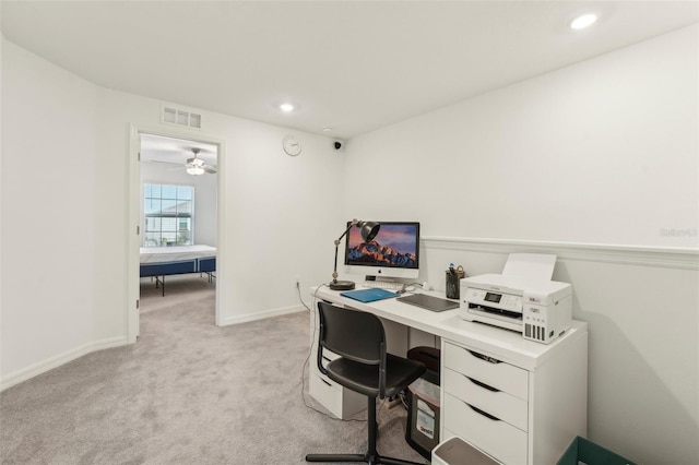 carpeted office space featuring ceiling fan