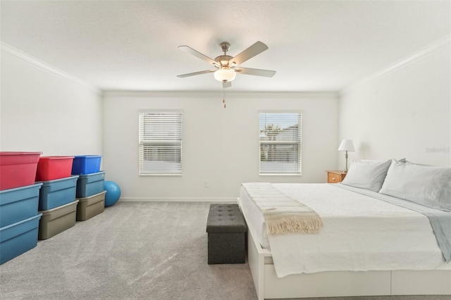 carpeted bedroom with ceiling fan and ornamental molding