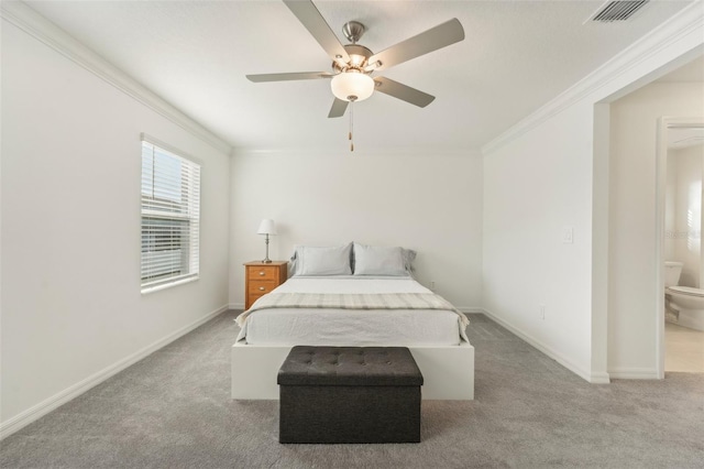 bedroom with light carpet, ceiling fan, ensuite bathroom, and crown molding