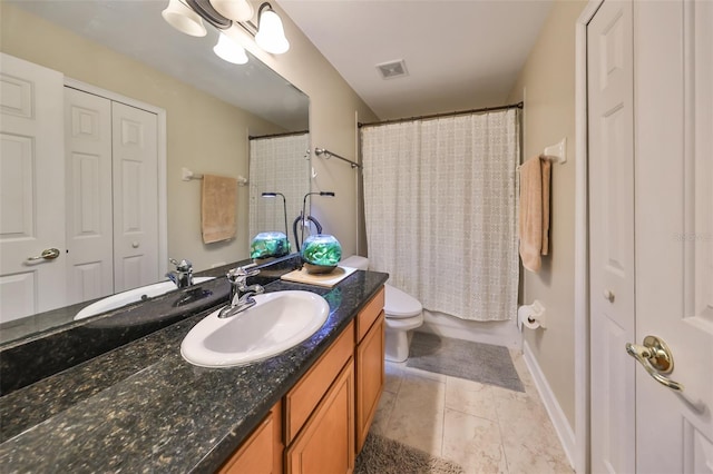 bathroom featuring tile patterned flooring, vanity, curtained shower, and toilet