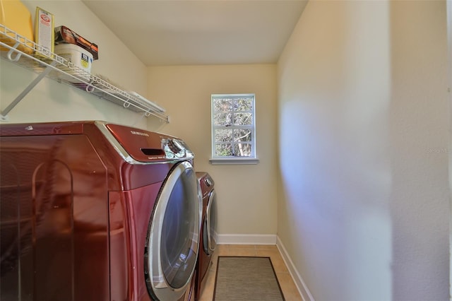 washroom with tile patterned flooring and washing machine and dryer