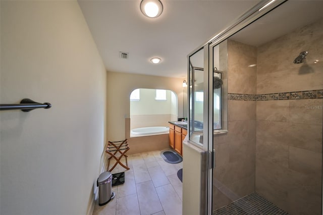 bathroom featuring tile patterned flooring and plus walk in shower