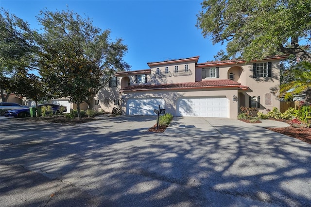 mediterranean / spanish home with a garage