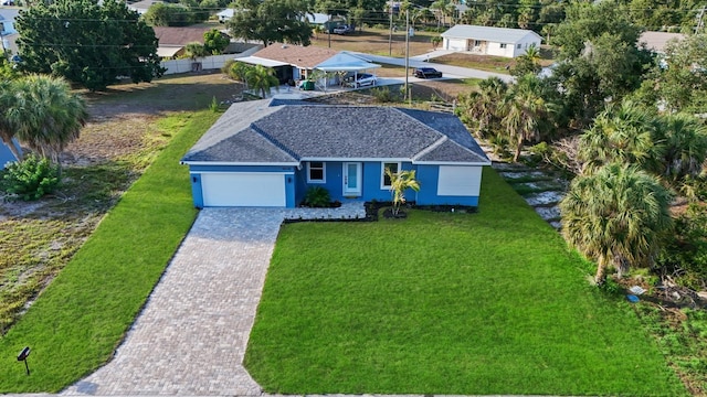 view of front facade featuring a garage and a front lawn