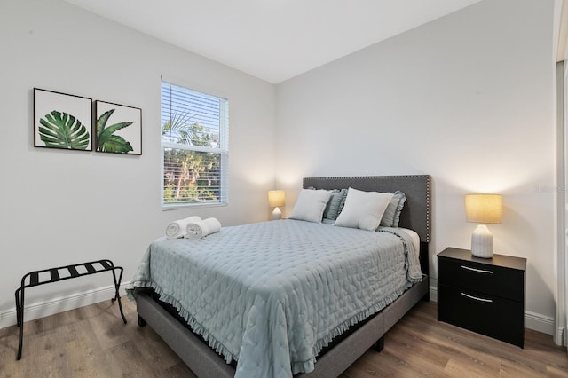 bedroom with dark wood-type flooring