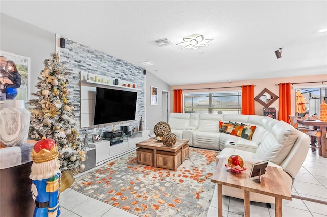 tiled living room featuring a textured ceiling