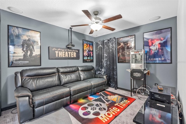 living room featuring ceiling fan, carpet, and a textured ceiling