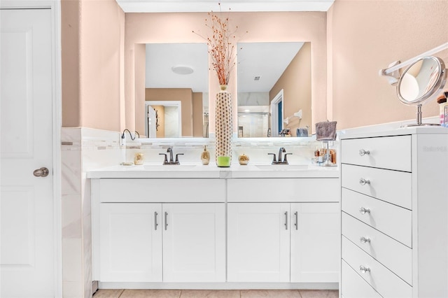 bathroom featuring tile patterned flooring, vanity, and walk in shower