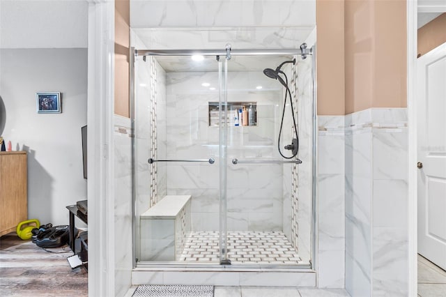 bathroom with hardwood / wood-style flooring and walk in shower