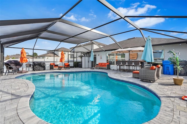 view of swimming pool with a lanai, exterior bar, and a patio