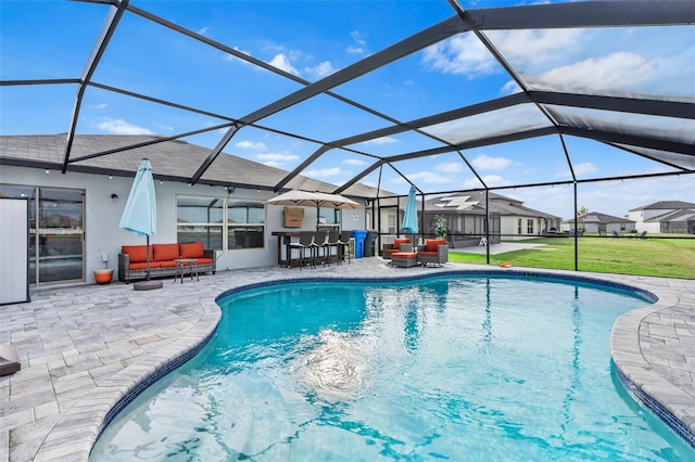 view of pool with a lanai, a patio area, an outdoor living space, and exterior bar