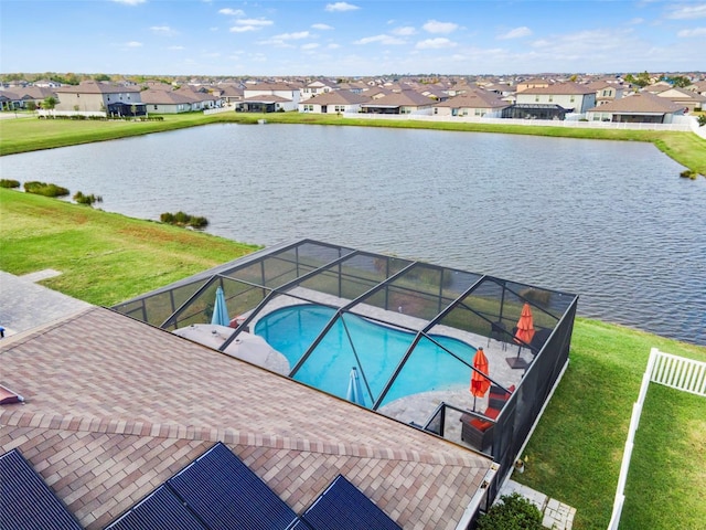 view of swimming pool featuring a yard and a water view