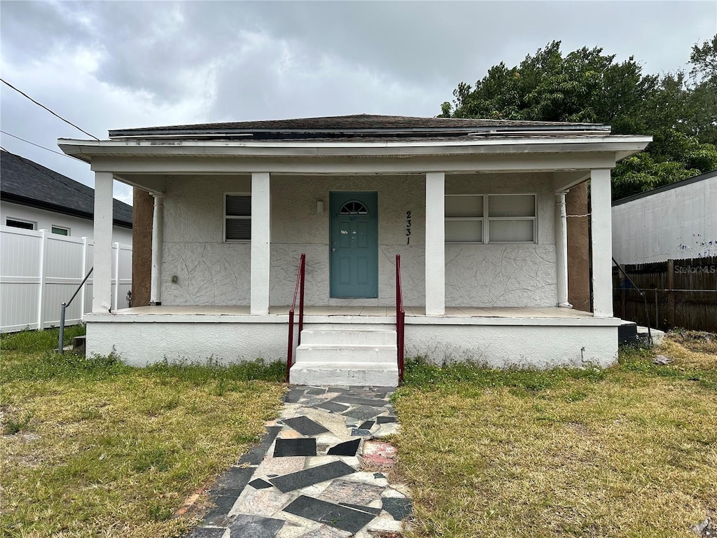 bungalow-style house featuring a front yard