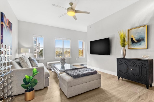 living room featuring light hardwood / wood-style flooring and ceiling fan