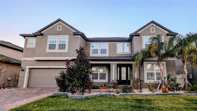 view of front of property featuring a garage and a front yard