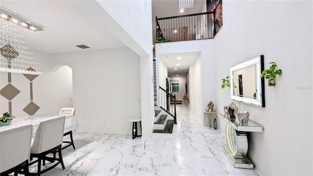 entrance foyer featuring a towering ceiling