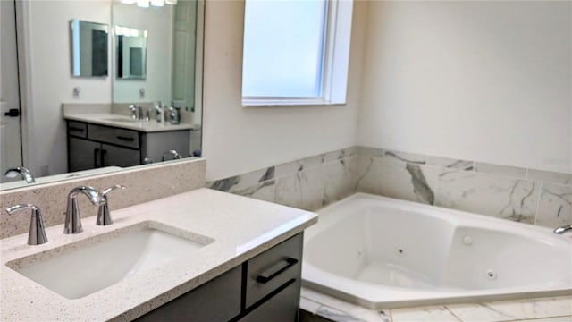 bathroom featuring vanity and a relaxing tiled tub