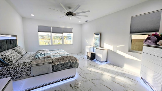 bedroom featuring ceiling fan and multiple windows