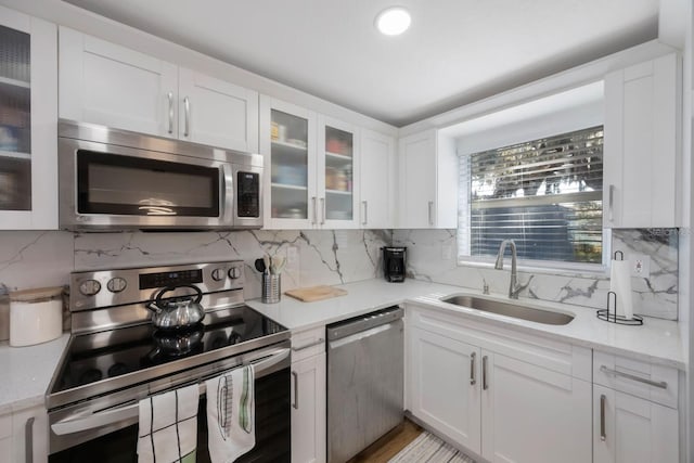 kitchen with white cabinets, sink, and stainless steel appliances