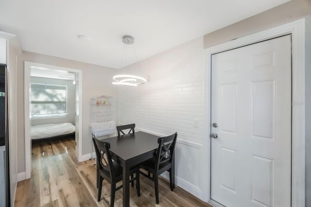 dining room with light hardwood / wood-style floors and a notable chandelier