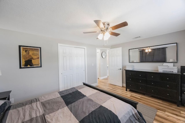 bedroom featuring ceiling fan, a closet, and light hardwood / wood-style floors