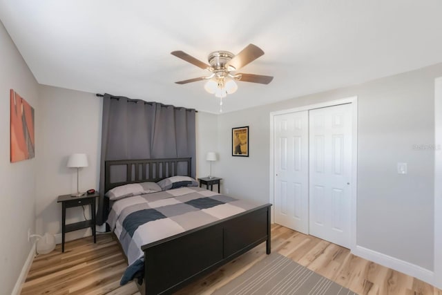 bedroom featuring a closet, light hardwood / wood-style floors, and ceiling fan