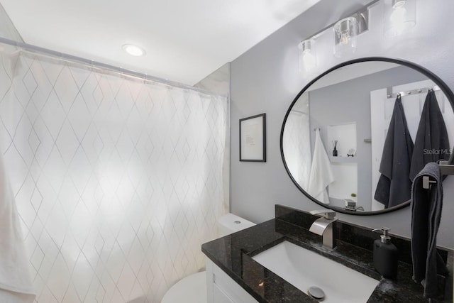 bathroom with a shower with curtain, vanity, and toilet