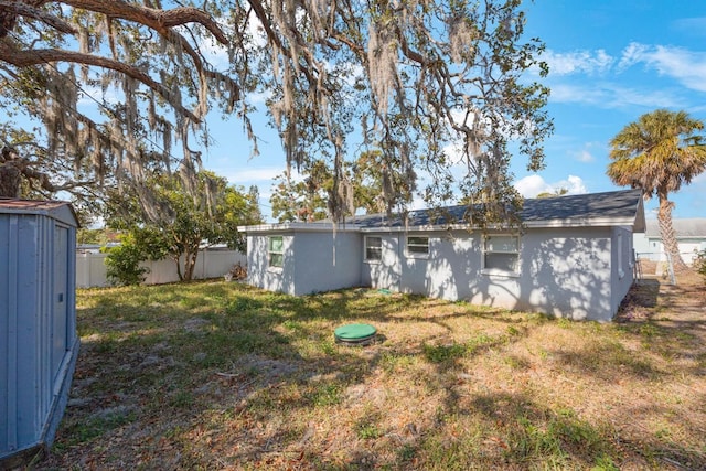 rear view of house with a yard